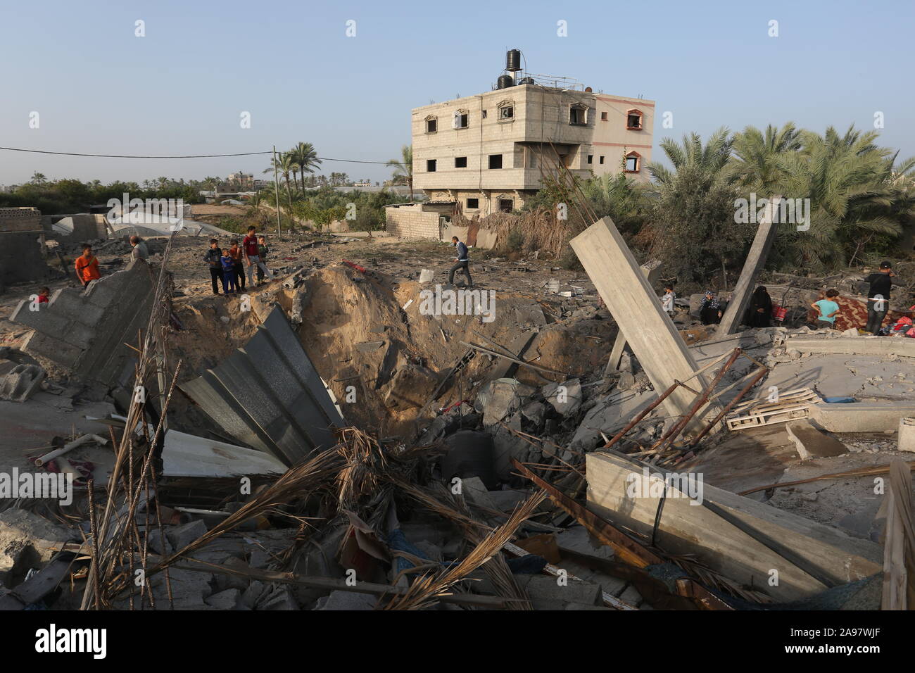 Les Palestiniens se rassemblent autour des vestiges d'une maison détruite dans un raid aérien israélien dans la bande de Gaza, le Nov 13, 2019. Photo par Abed Rahim Khatib Banque D'Images