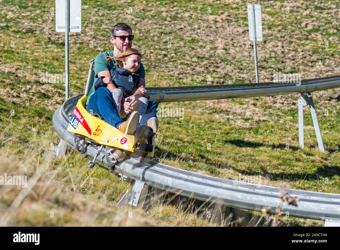 Père avec enfant sur luge d'été piste / panorama erlebnis Brücke / fun bob Banque D'Images