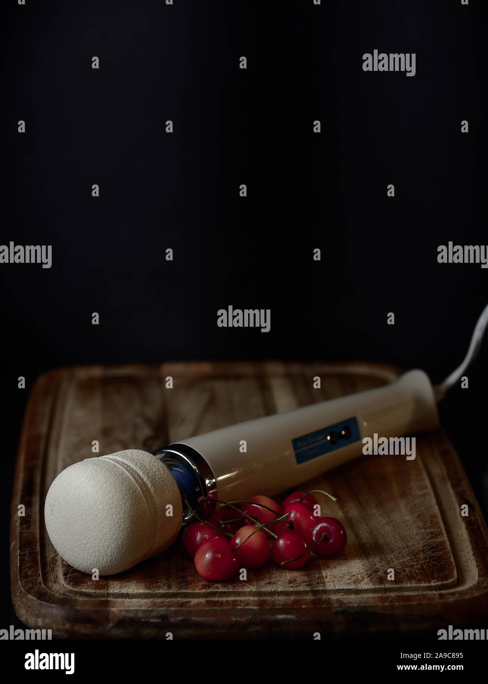 Baguette magique sur une planche en bois avec cerises Banque D'Images