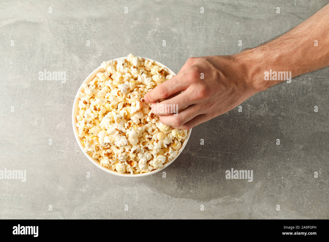 Côté masculin et du godet avec du popcorn sur fond gris, vue d'en haut Banque D'Images