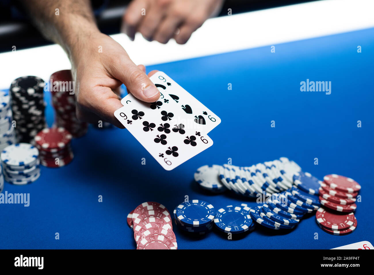 Man playing poker Texas Hold'em au casino, il est maintenant deux cartes Banque D'Images