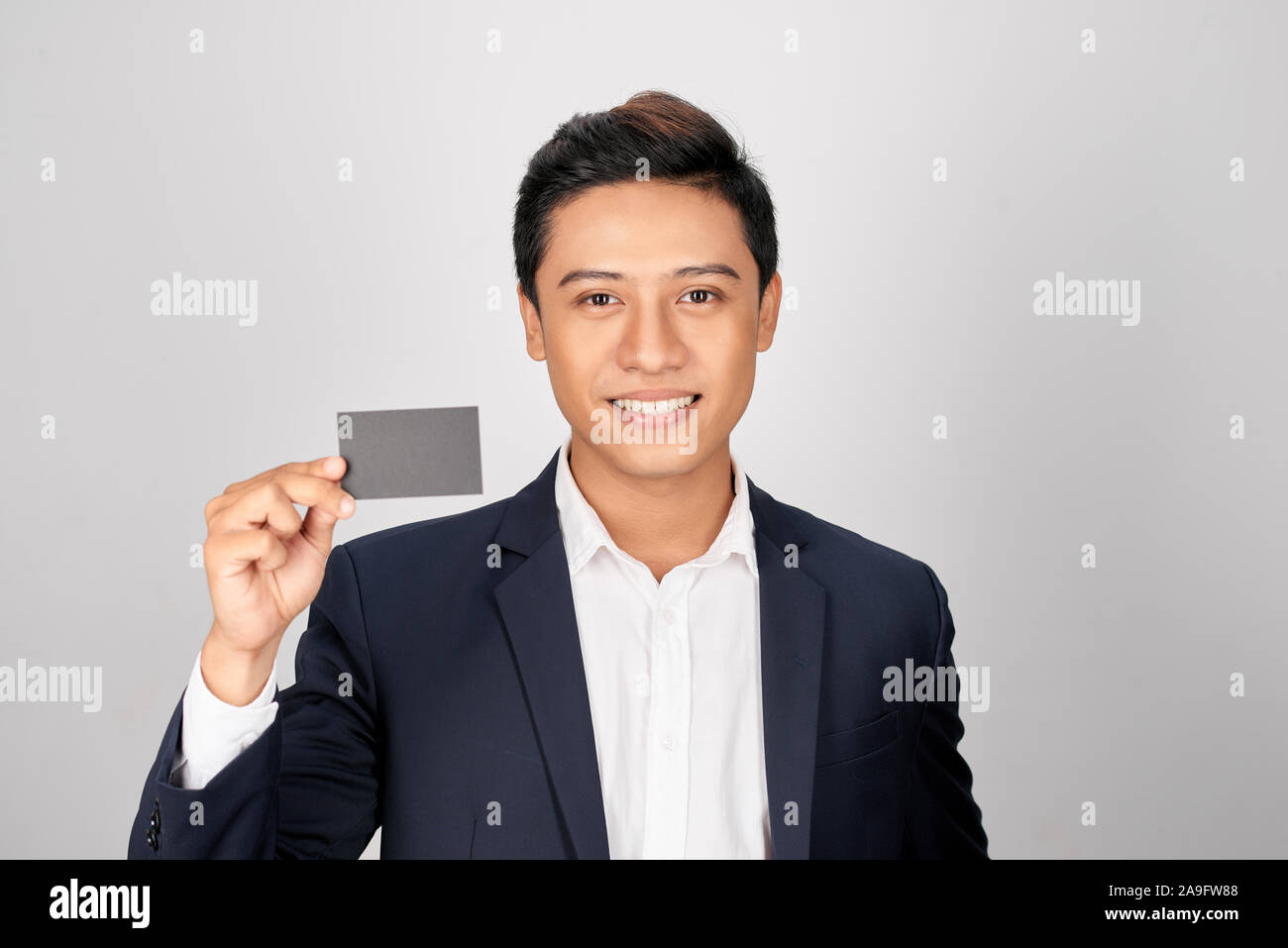 Portrait of young asian man montrant une carte de visite Banque D'Images