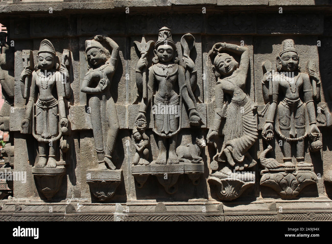 Brahma, Vishnu, Mahesh et danser les femmes de la sculpture sur pierre, Shree Ganga temple Godavari, Nashik, Maharashtra, Inde Banque D'Images