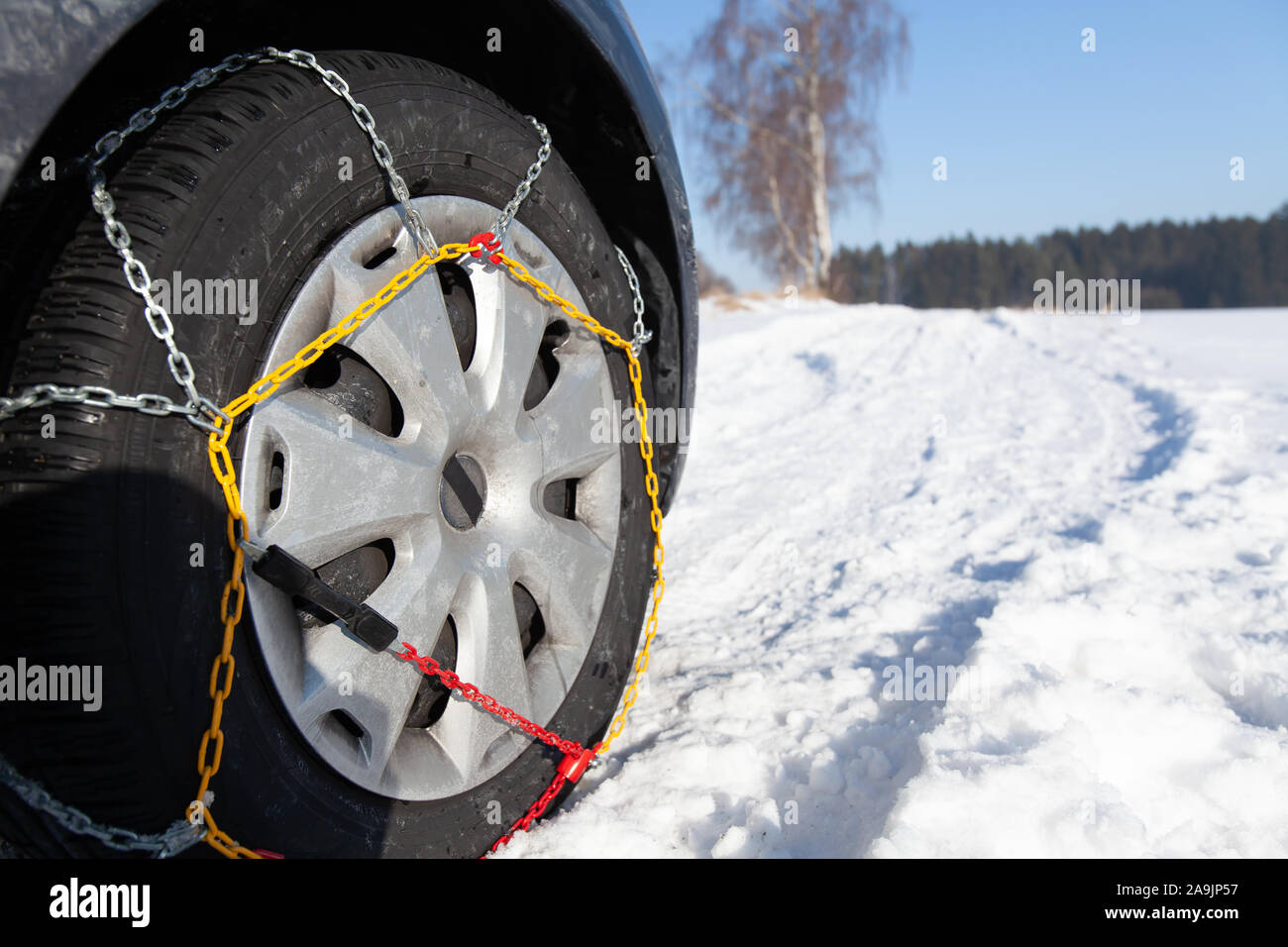 Voiture coincé dans la neige. Pneu équipé avec des chaînes à neige. Banque D'Images