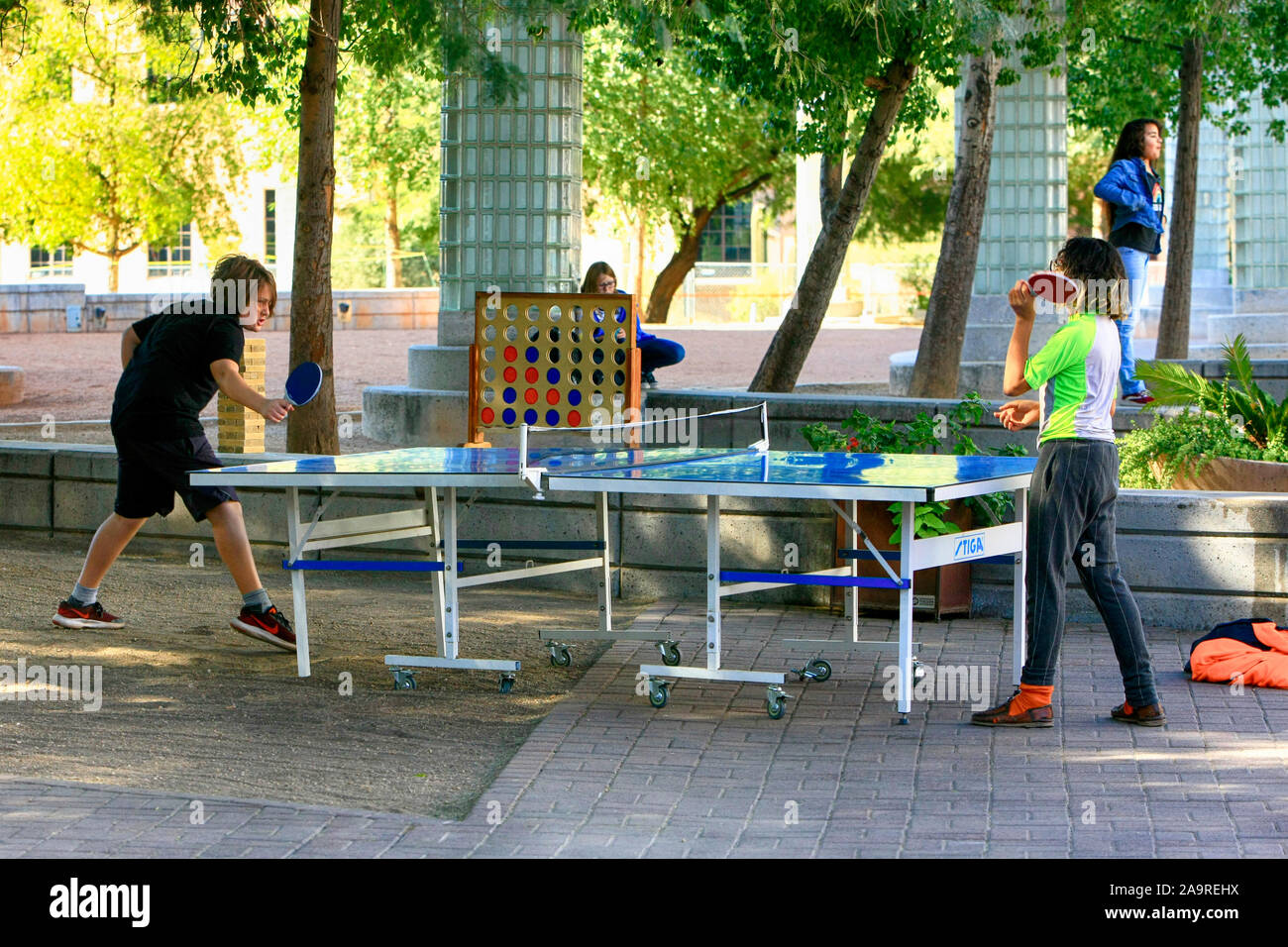 Deux adolescents jouant au tennis de table dans la Carlos Corella Jacome Plaza près de la bibliothèque dans Tucson AZ Banque D'Images