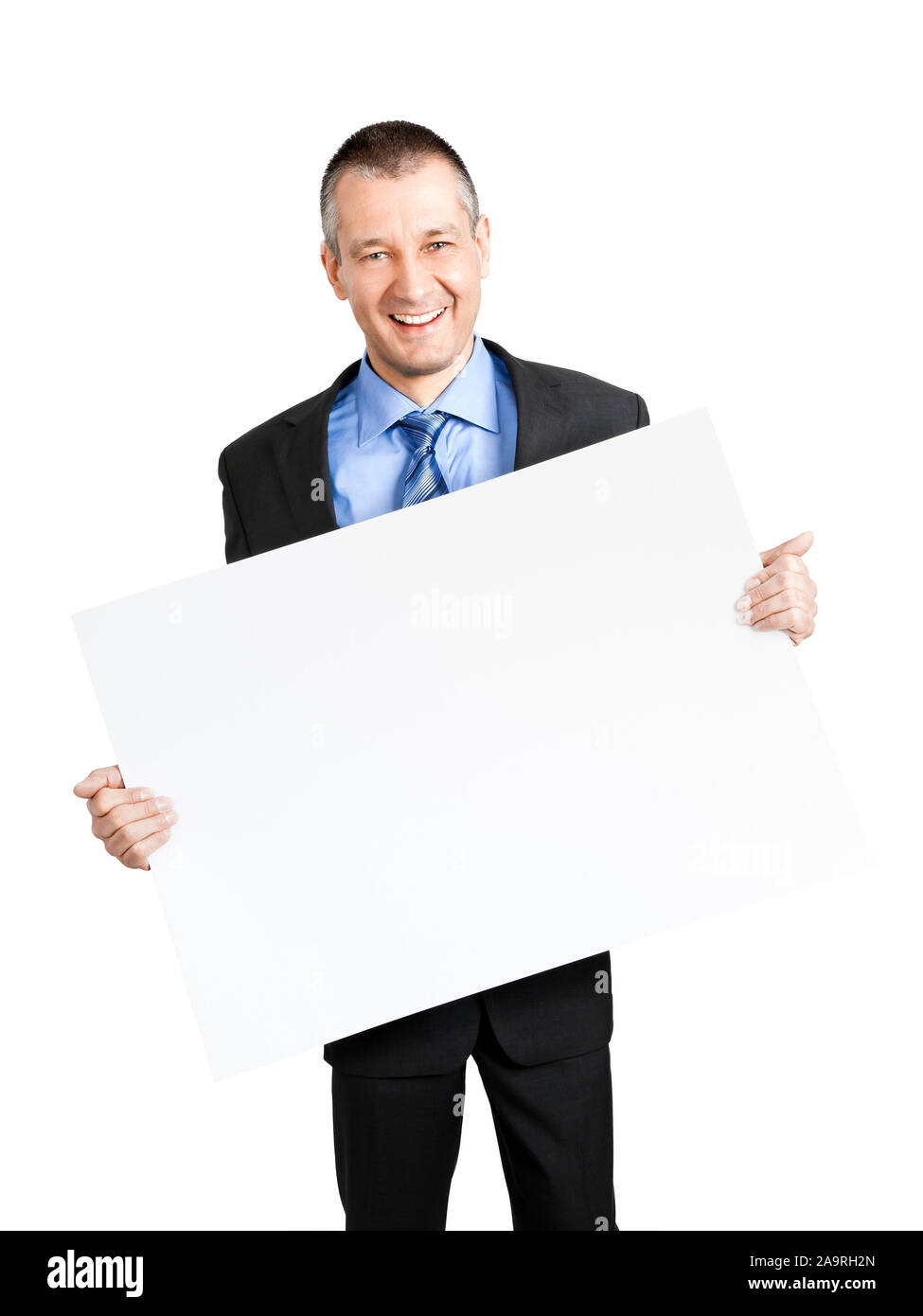 Ein lachender Geschaeftsmann mit einem Schild in der Hand, vor weissem Hintergrund Banque D'Images