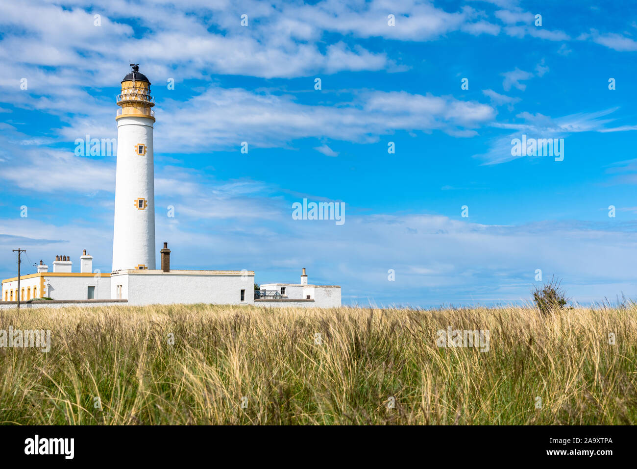 Barns Ness Phare sur la côte Est de l'Ecosse et ciel bleu avec des nuages Banque D'Images