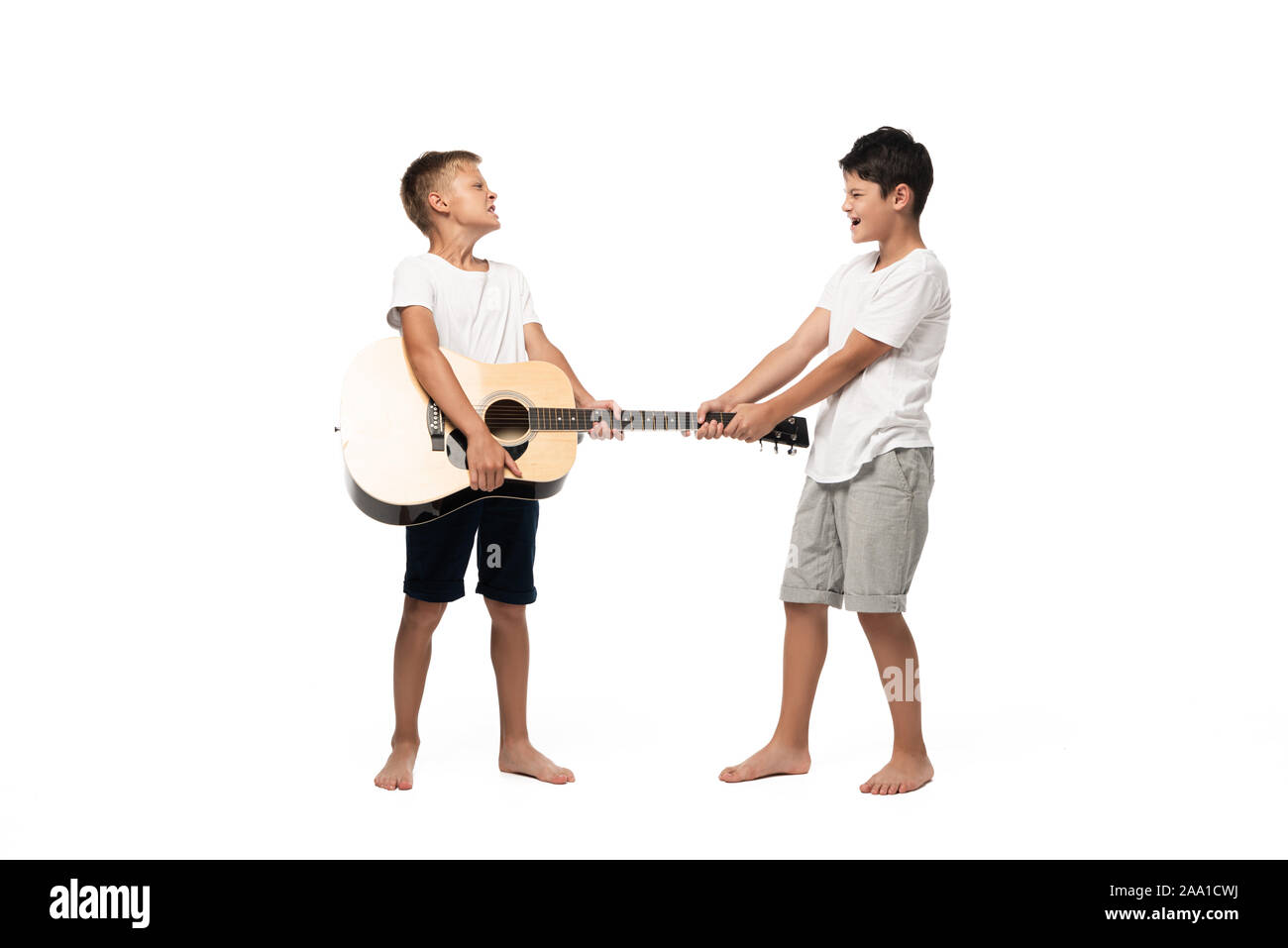Deux frères à la caméra et à danser tout en écoutant la musique au casque sur fond blanc Banque D'Images
