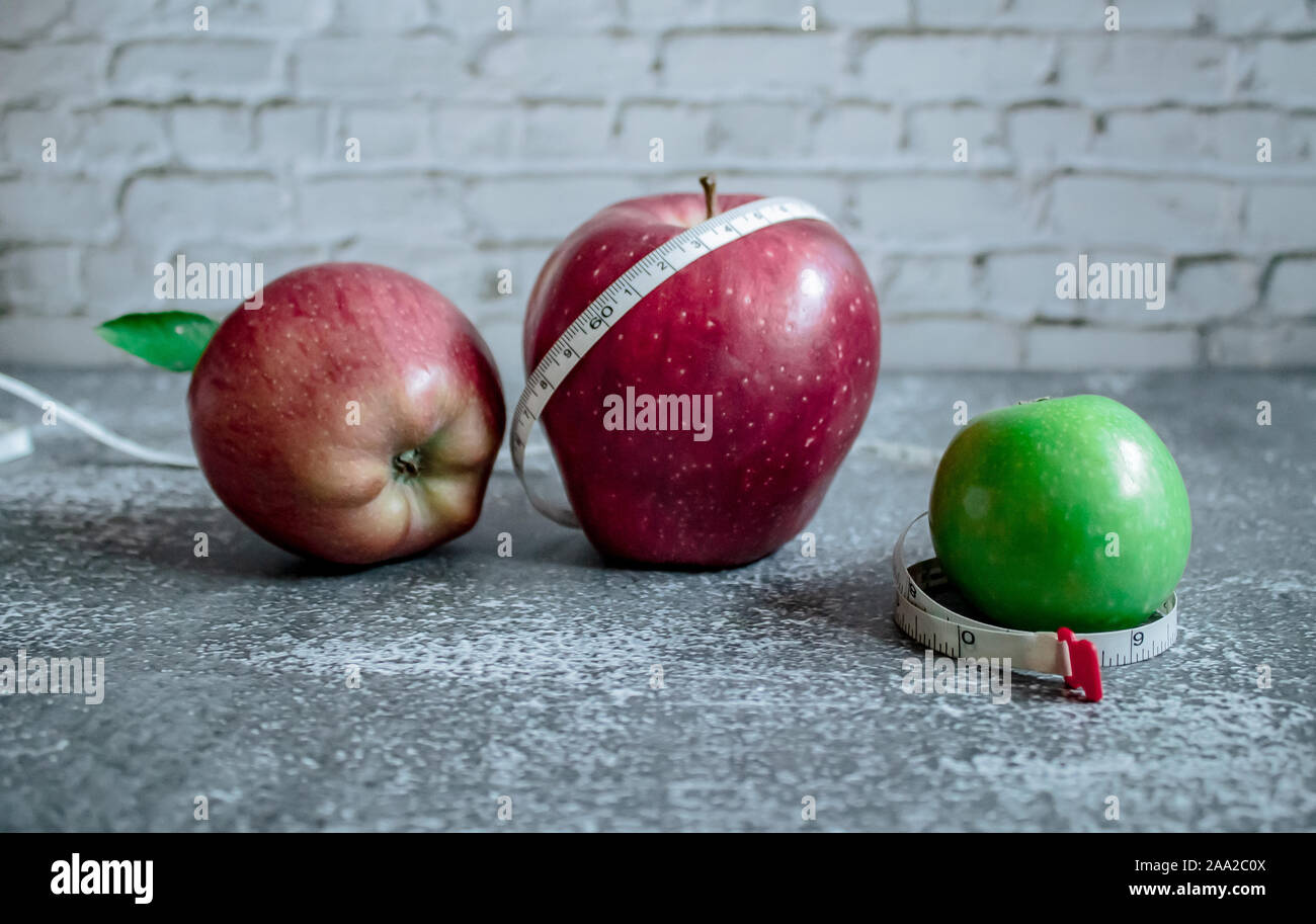 Pomme verte et rouge pour la perte de poids tout en suivant un régime,  centimètre ruban à mesurer Photo Stock - Alamy
