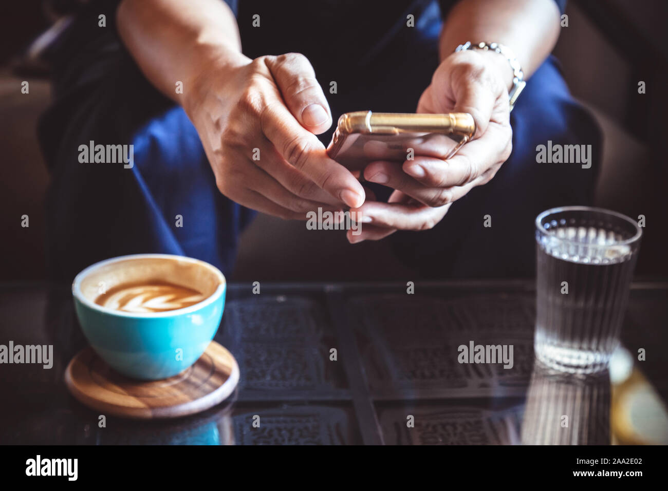 Businessman using smartphone pour lire les nouvelles en matière de placement et de réponse e-mail pour confirmer réunion à café. man drinking latte avant de se rendre au travail Banque D'Images