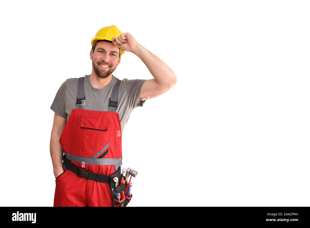 Cheerful worker - artisan dans les vêtements de travail isolé sur fond blanc - Banque D'Images