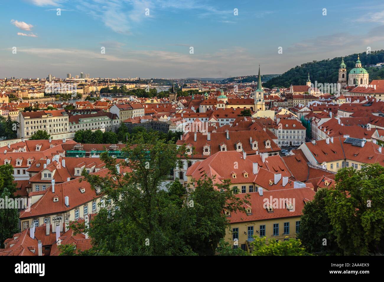 Prague, République tchèque - 20 juillet 2019 - Vue sur les toits rouges, paysage urbain avec des églises et bâtiments historiques. Soirée bleu ciel avec des nuages. Banque D'Images