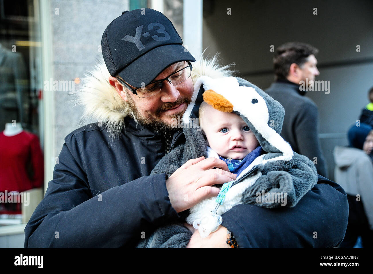 Stirling, Stirlingshire, UK. 17 novembre, 2019. Un homme avec kid hid regarder le défilé passer par lors de l'événement.Stirling est sorti pour commencer la période des fêtes de Noël avec leur lumière tournez sur l'événement, c'est un événement annuel qui a lieu le 17 novembre. Conseil Stirling organiser un concours pour voir qui sera chanceux et s'asseoir à côté de Santa pour la parade et d'avoir l'honneur de faire le commutateur. Cette année a vu Clara-Louise Hamill et sa famille d'avoir l'honneur. Crédit : Stewart Kirby/SOPA Images/ZUMA/Alamy Fil Live News Banque D'Images