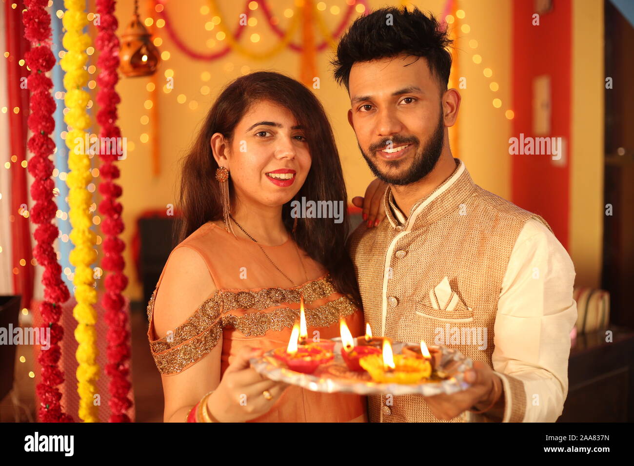 Couple indien célèbre Diwali. Isolé sur fond de décoration. Banque D'Images