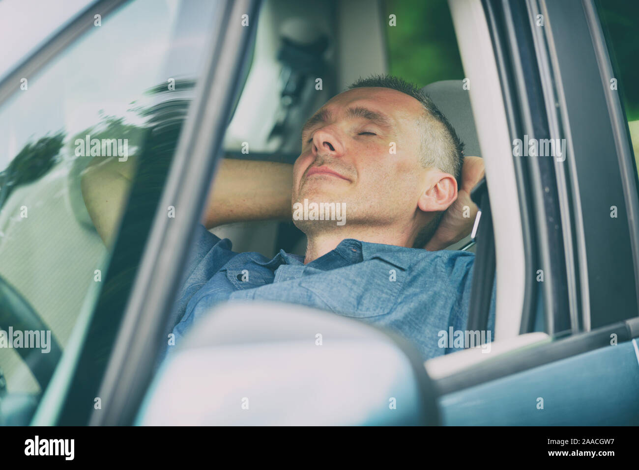L'homme de dormir dans la voiture avant la prochaine partie du voyage Banque D'Images