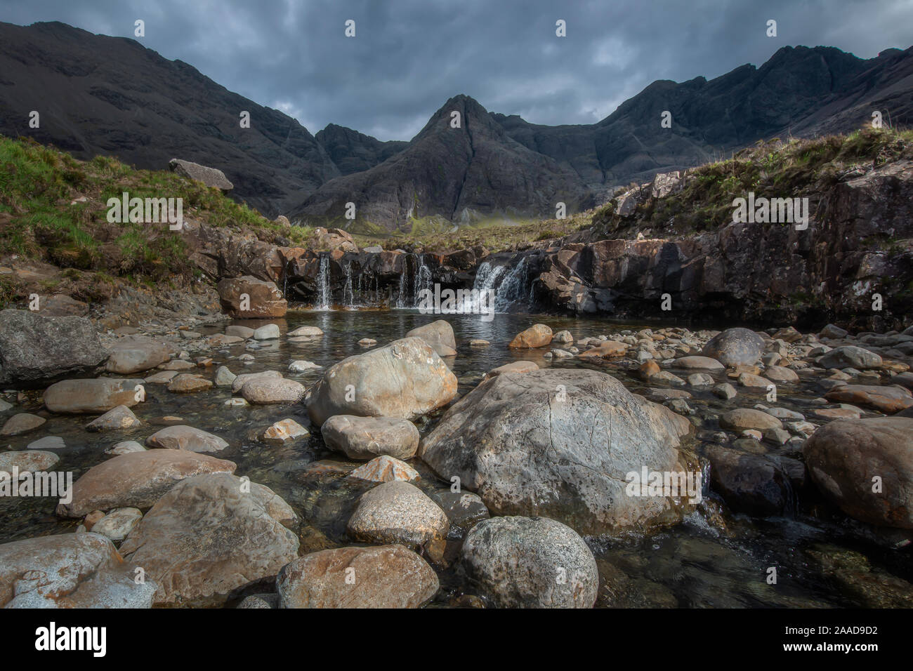 Ciel dramatique au-dessus de pools de fées, des étangs aux eaux cristallines, de cascades et de rochers colorés en scenic Mountain Valley sur l'île de Skye, Écosse, Royaume-Uni. Banque D'Images