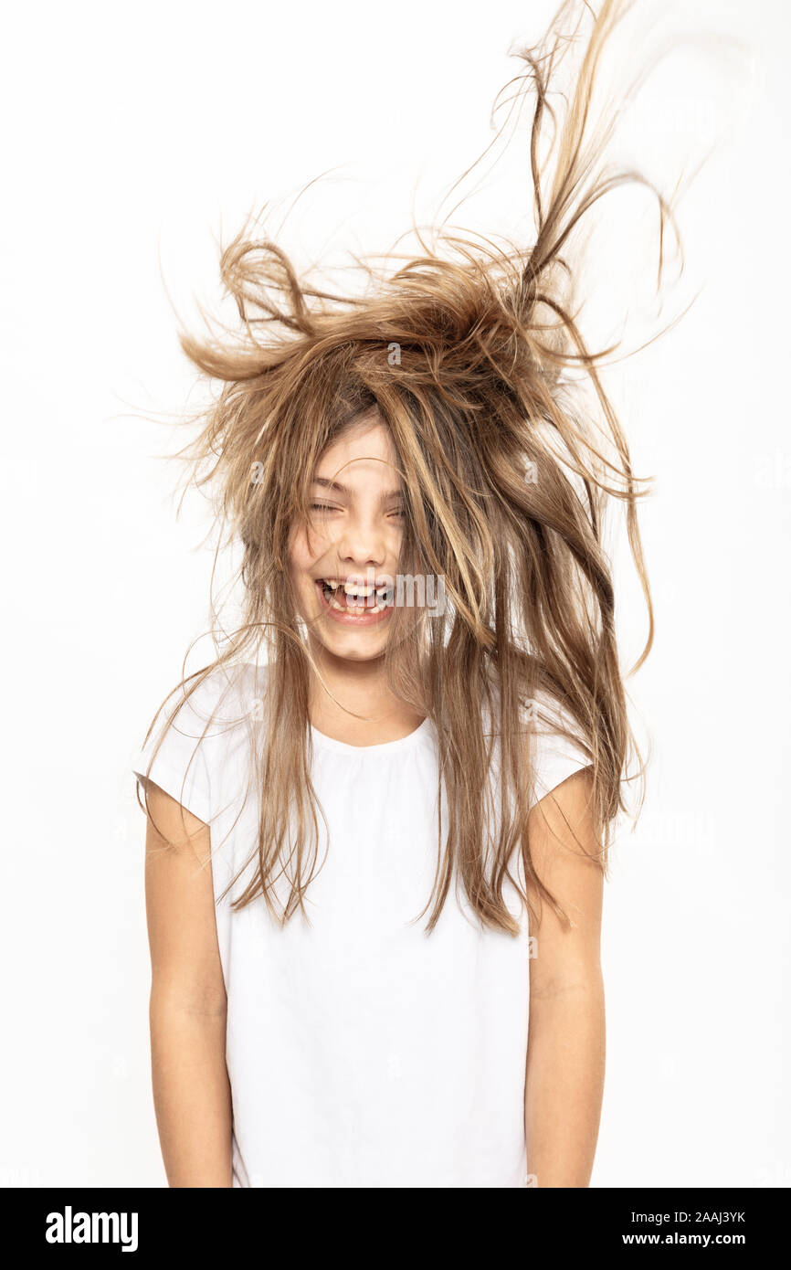 Happy girl with flying hair, fond blanc Banque D'Images