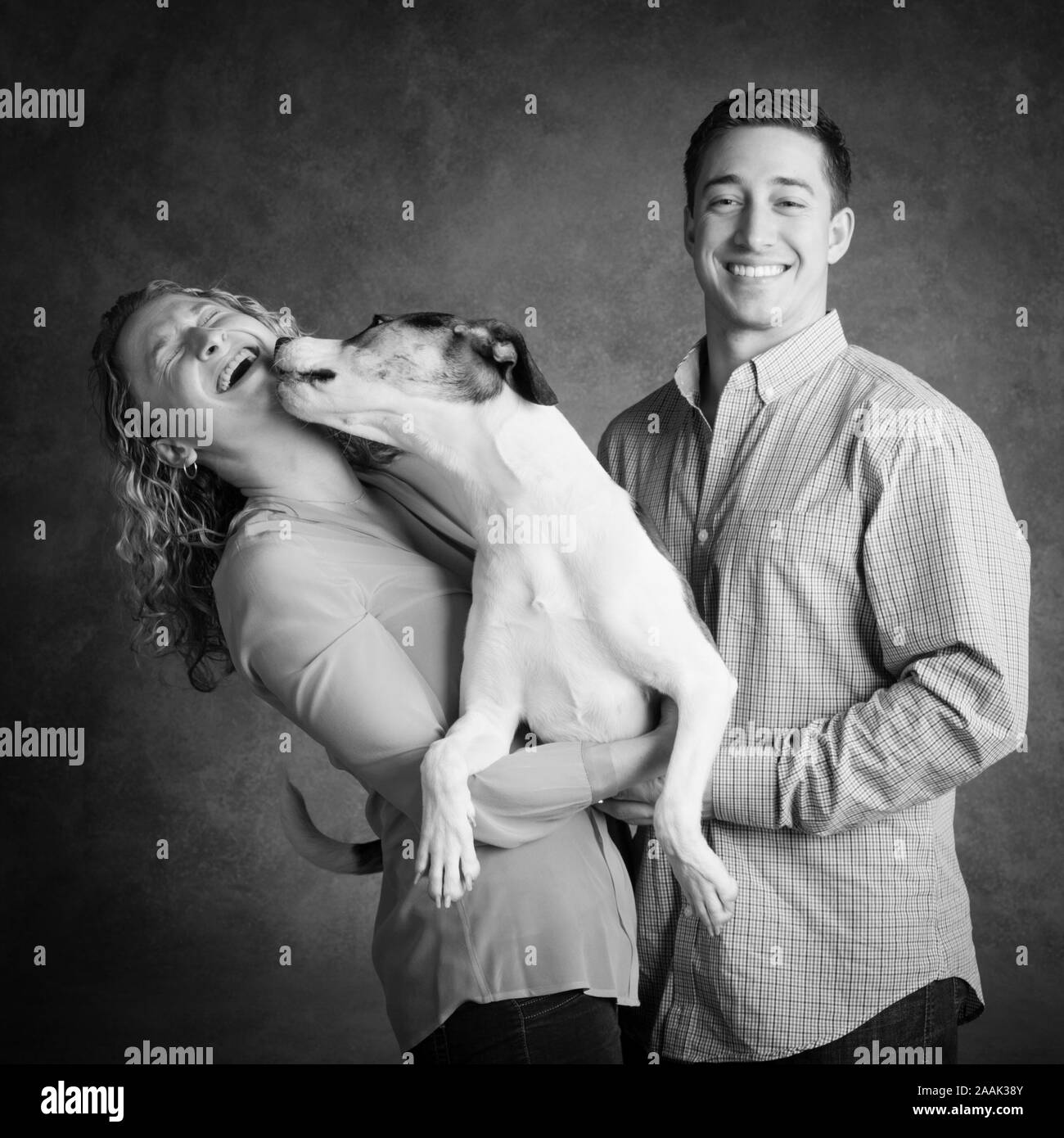 Studio shot of couple with dog Banque D'Images