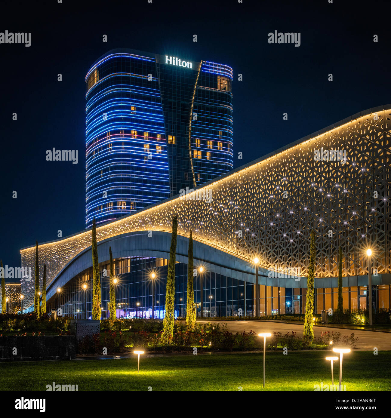 Tachkent, Ouzbékistan - 30 octobre, 2019 : Salle des congrès et l'hôtel Hilton avec éclairage coloré dans la nuit dans le parc de la ville de Tachkent Banque D'Images