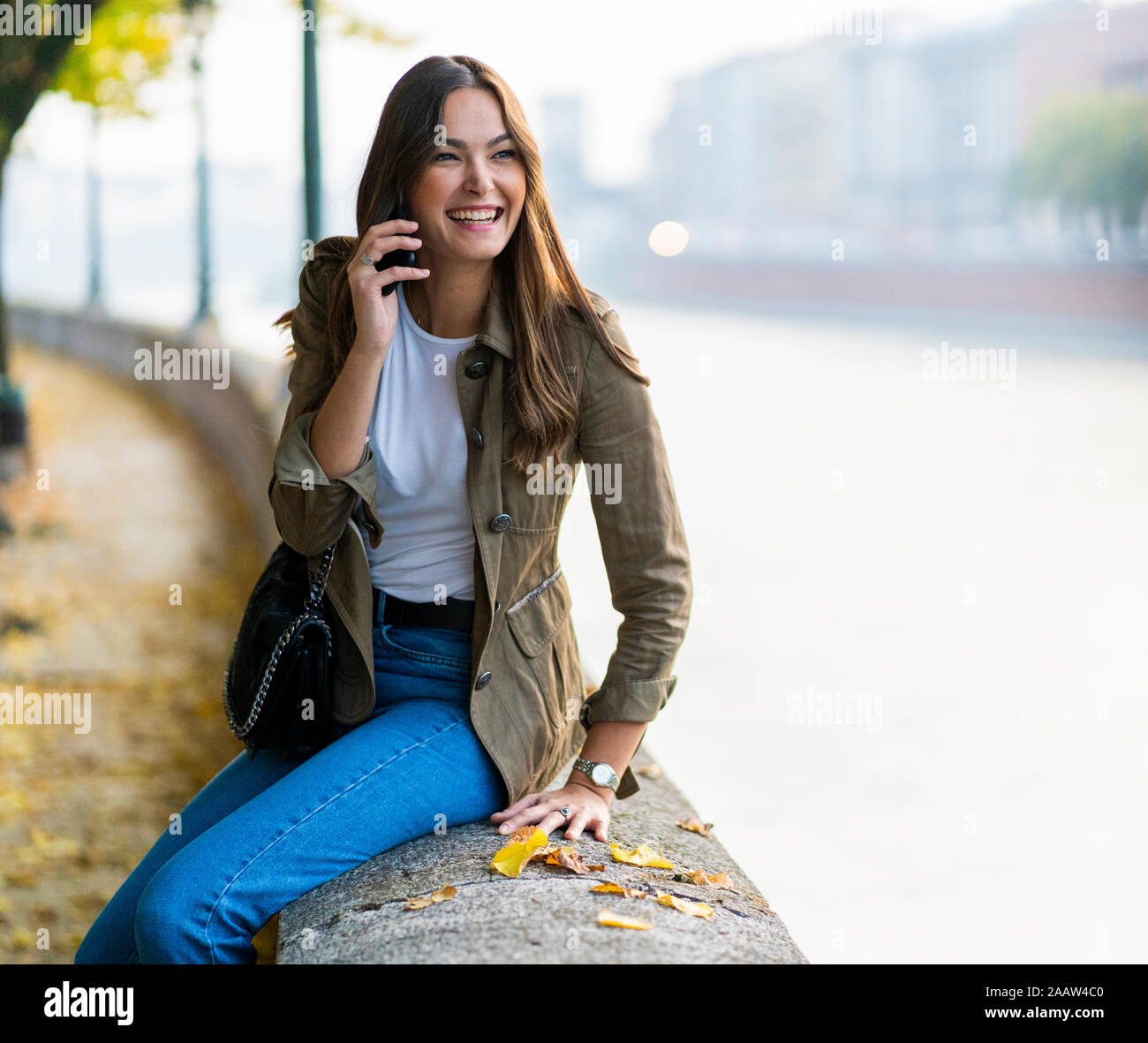Jeune brunette woman using smartphone à Vérone, Italie Banque D'Images