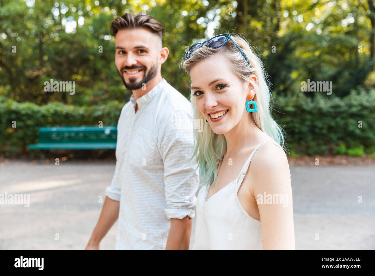 Portrait of happy young couple walking in a park Banque D'Images