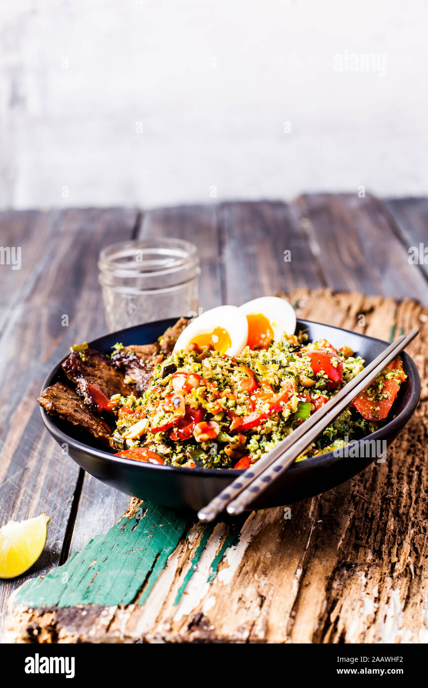 Style thaï fried rice (Brocoli Brocoli râpé) avec des tranches de bœuf, les œufs, et sauce épicée (régime cétogène, paleo diet, low carb) Banque D'Images