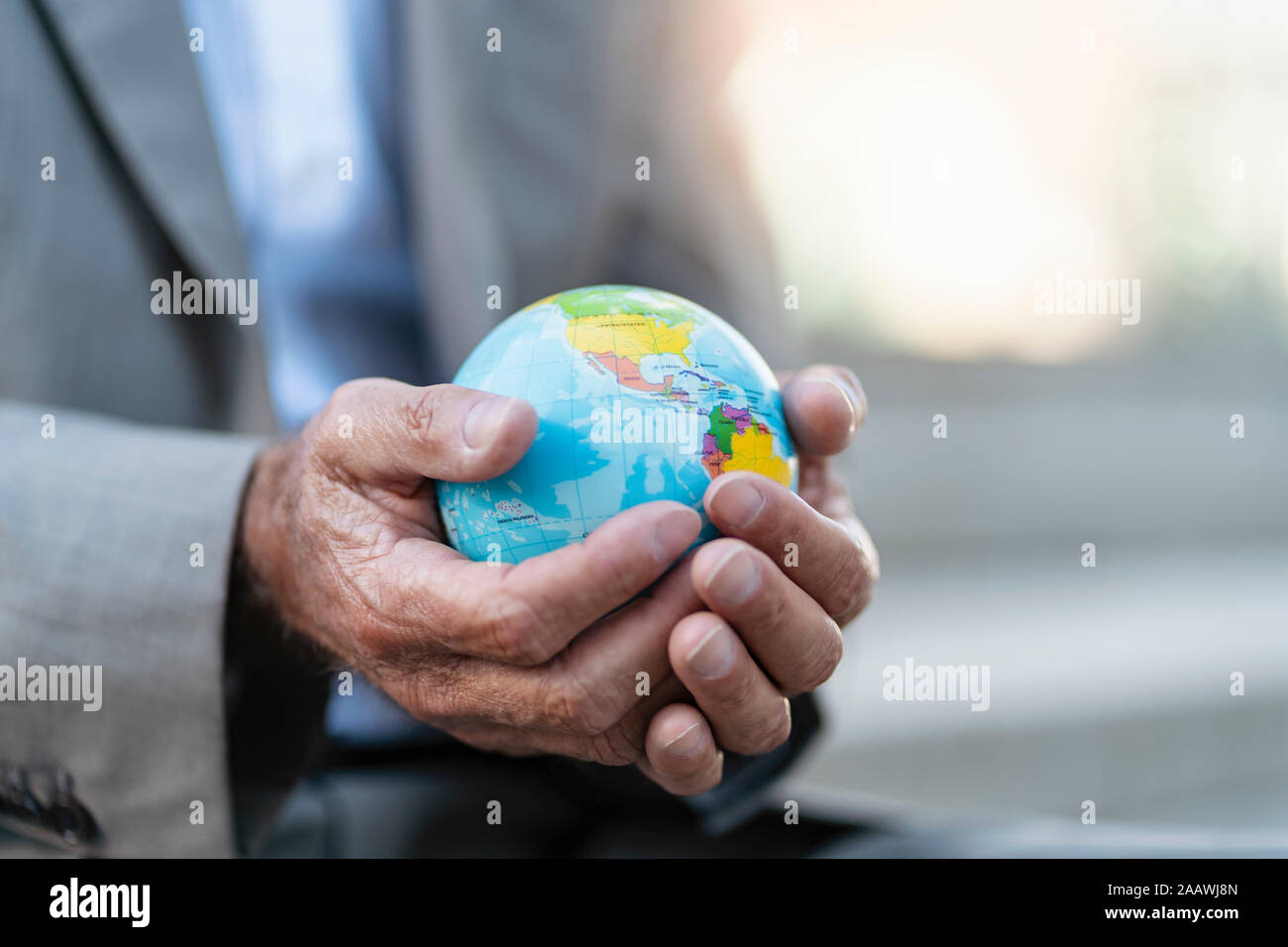 Close-up of hands of businessman holding globe Banque D'Images