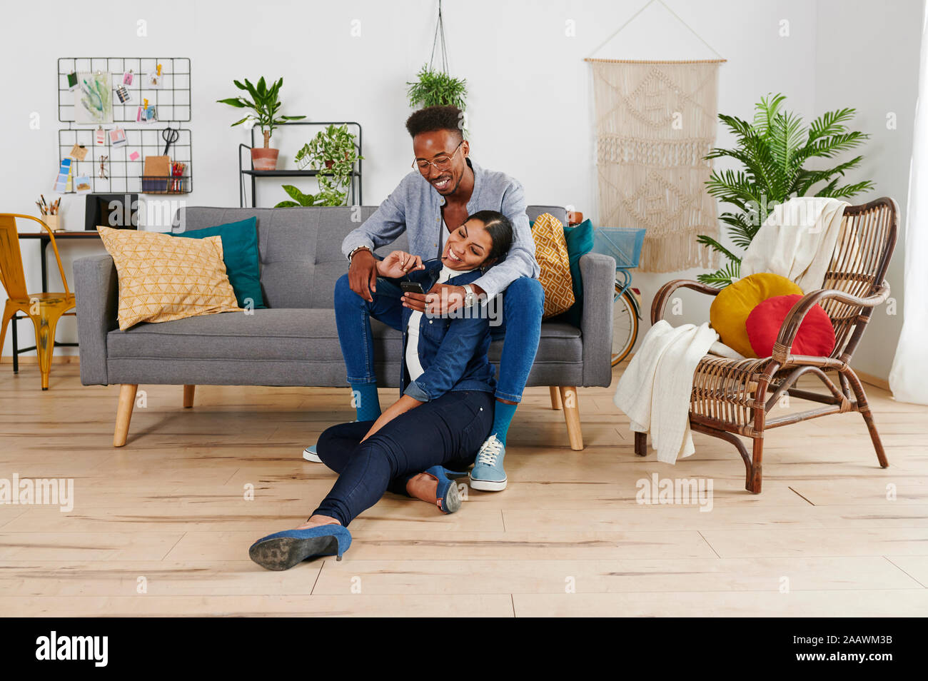 Couple multiethnique de passer du temps ensemble au salon, prenant un selfies Banque D'Images
