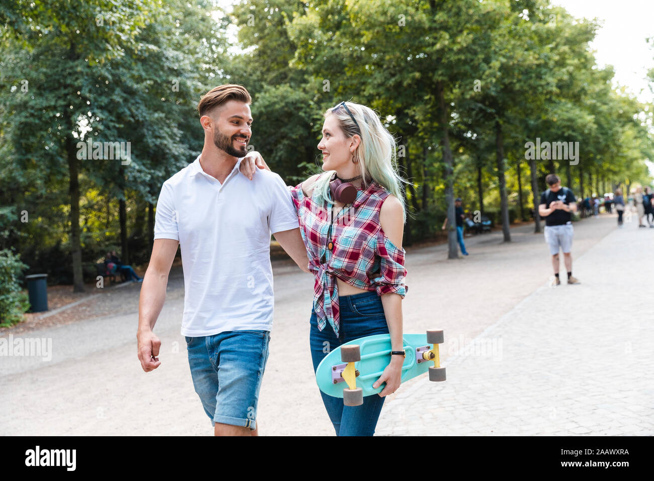 Happy young couple walking in a park Banque D'Images