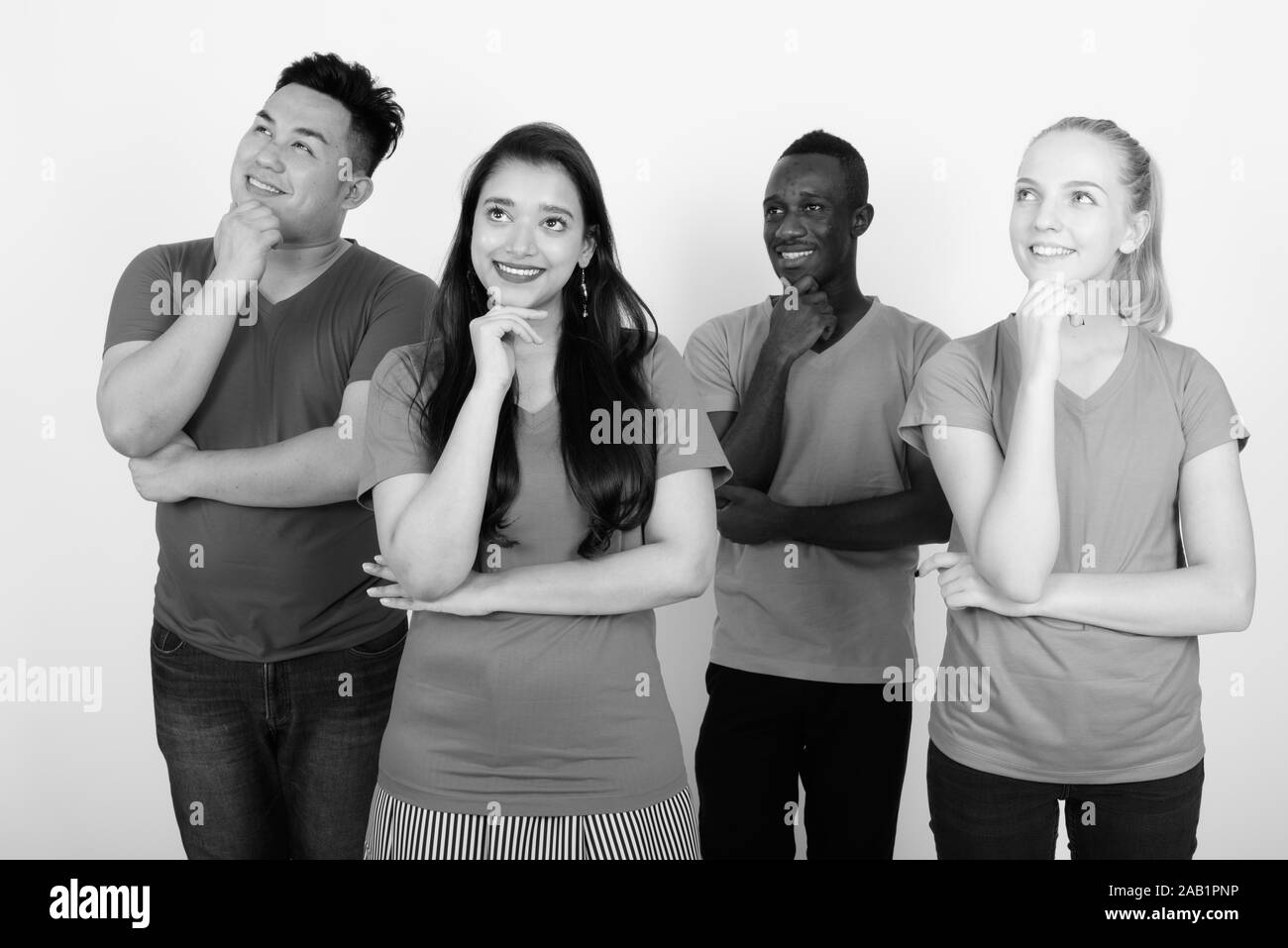 Studio shot of happy groupe diversifié de multi ethnic friends smiling et penser ensemble with hand on chin Banque D'Images