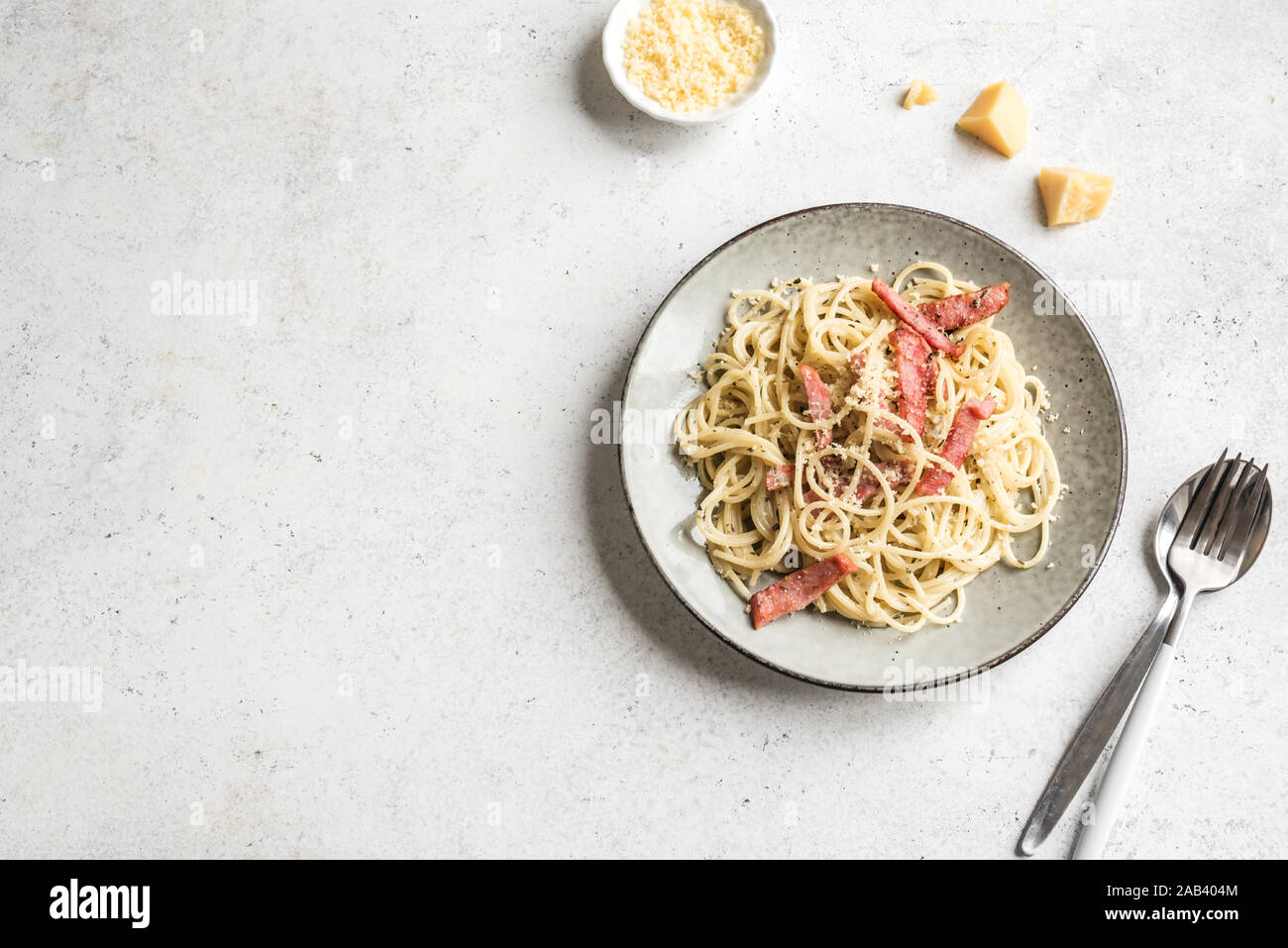 Spaghetti Carbonara, pâtes avec bacon, oeufs durs, fromage parmesan et sauce à la crème. Cuisine italienne Pasta alla carbonara sur blanc, vue du dessus, copiez sp Banque D'Images