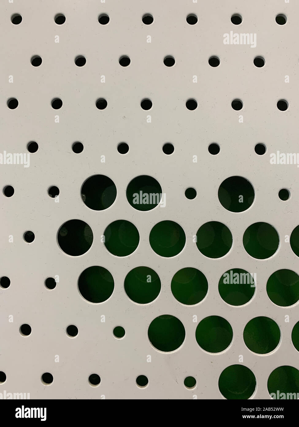 Vue rapprochée de la surface de métal blanc avec fond de couleur verte. Motif graphique en pointillé est coupé. Banque D'Images