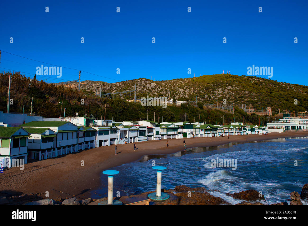 Platja de Les Casetes del Garraf, Garraf, Barcelone, Catalogne. Ces petites maisons de plage vert et blanc sont dans le village balnéaire de Garra Banque D'Images