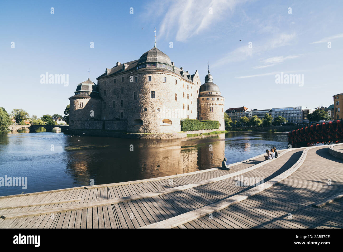 Orebro, Suède - août 2017 : les gens se détendre en face de l'ancien château d'Orebro au coucher du soleil Banque D'Images