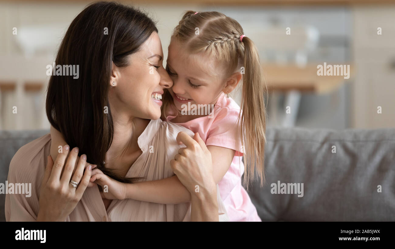 Douce petite fille hug prendre soin jeune maman câlin on couch Photo Stock  - Alamy