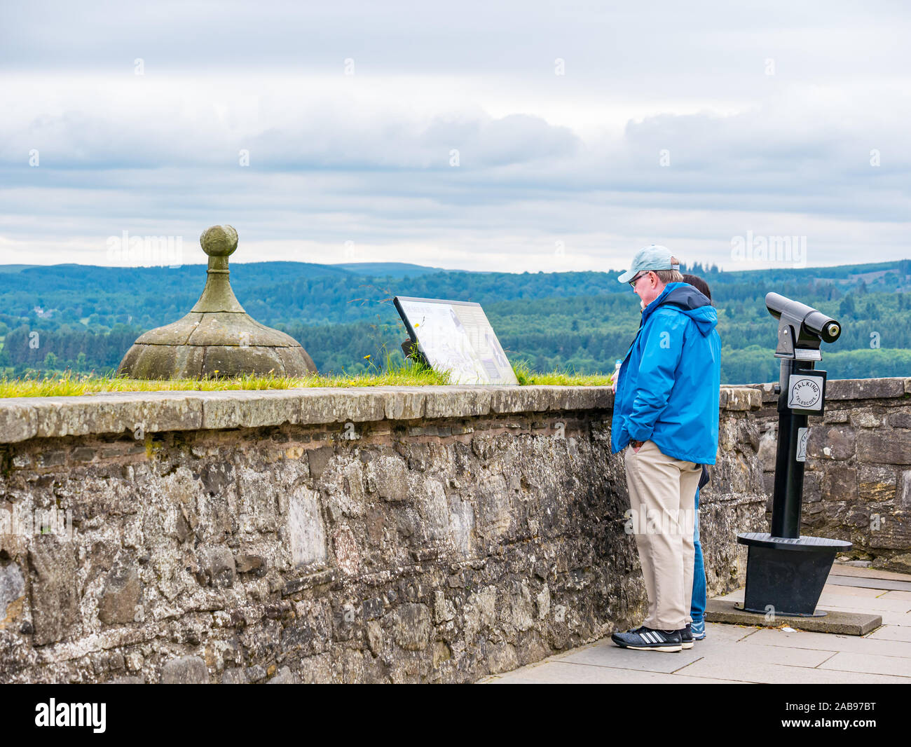 Faire les touristes à la recherche d'information au point de vue du conseil sur le mur du château de Stirling, Scotland, UK Banque D'Images