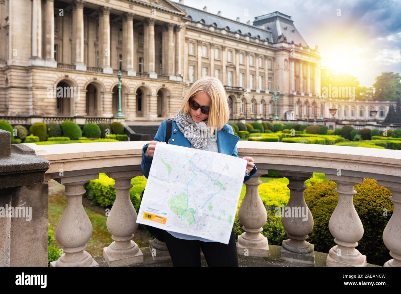 Une femme lit un plan de ville sur fond de Palais Royal de Bruxelles, Belgique Banque D'Images