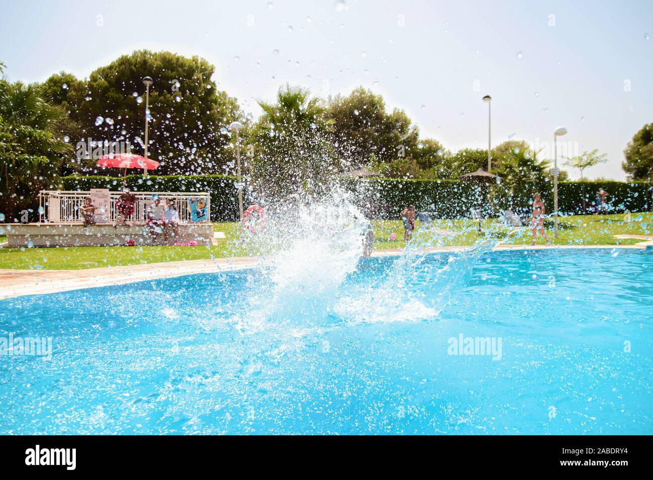 Saut dans une piscine pour enfants création d'un géant les éclaboussures d'eau. Beau temps, l'heure d'été ! Très lumineux et coloré tourné, eau bleu clair. Banque D'Images Saut dans une piscine pour enfants création d'un géant les éclaboussures d'eau. Beau temps, l'heure d'été ! Très lumineux et coloré tourné, eau bleu clair. Banque D'Images