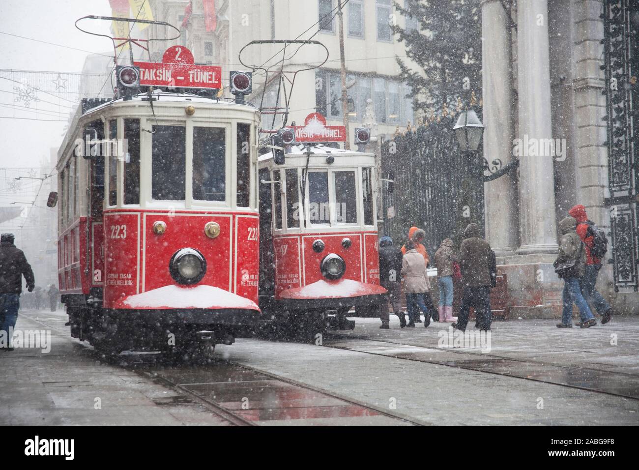 Taksim, Istanbul, Turquie - 8 janvier 2013 : un nostalgique des tramways passant par à l'avant du Lycée de Galatasaray à l'Istiklal Street quand il neige. Banque D'Images