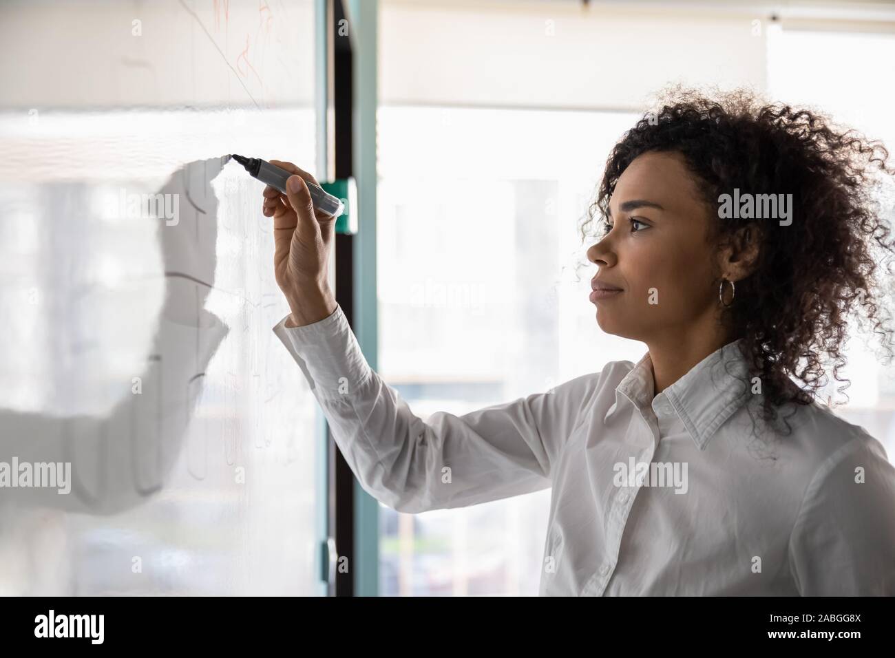 African American female écrire à bord de l'élaboration du plan d'affaires Banque D'Images