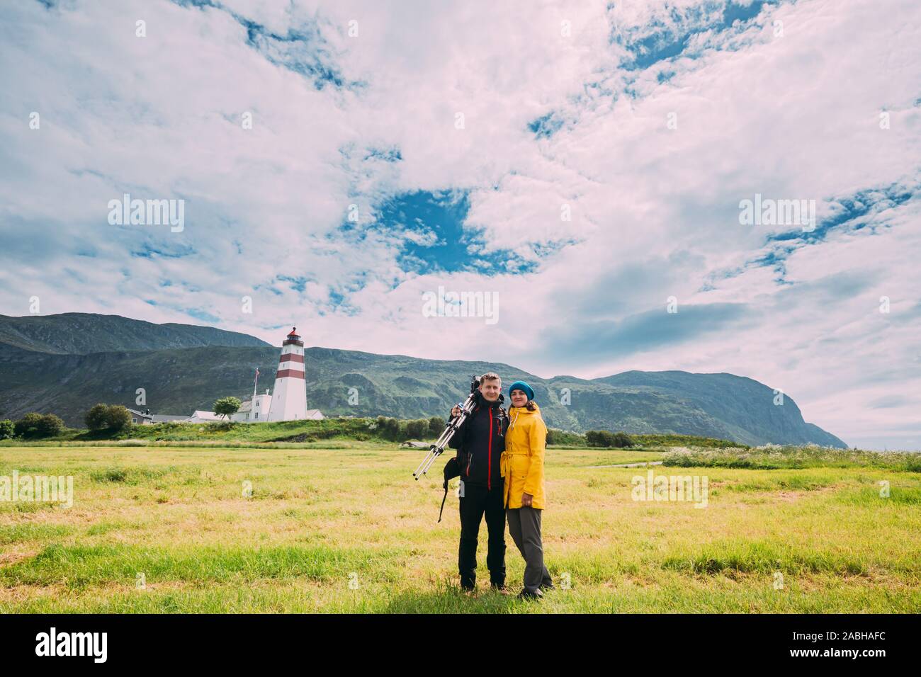 Alnesgard Godoya,, en Norvège. L'homme et la femme jeune adulte Caucasian Couple Voyageurs touristes contre vieux phare Alnes en journée d'été en Godoy est Banque D'Images