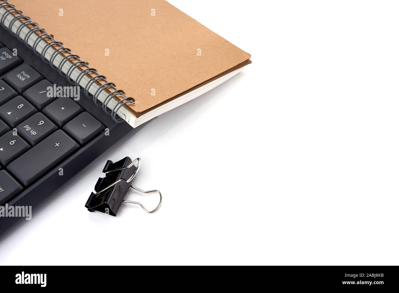 Office de bureau avec groupe de black metal binder clip papier, colliers et clavier remarque livre isolé sur blanc - droit Banque D'Images