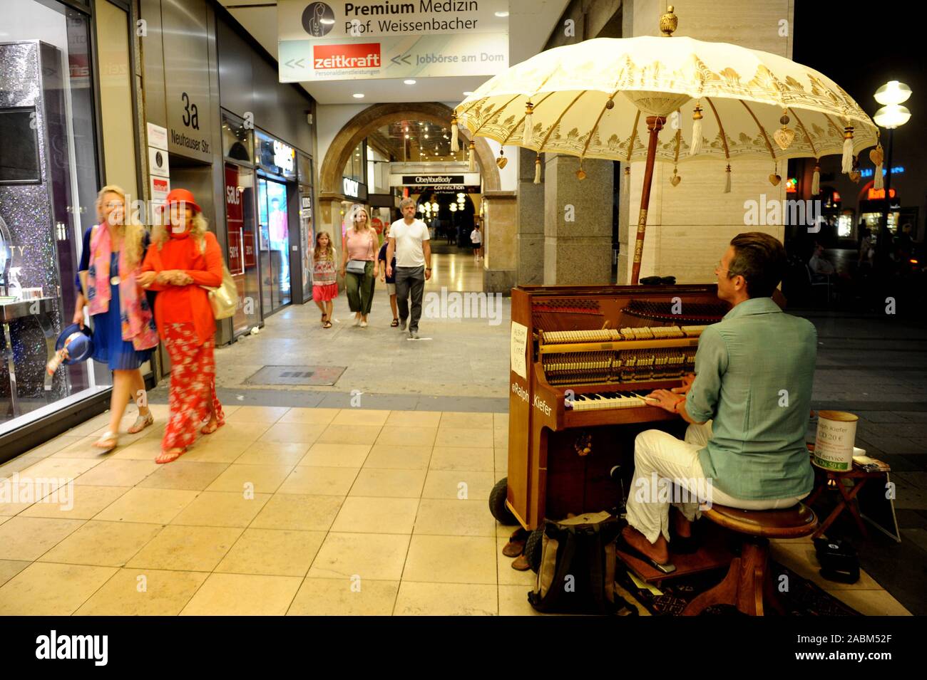 Un musicien de rue joue sur une chaude nuit d'été dans la zone piétonne de Kaufingerstraße. [Traduction automatique] Banque D'Images