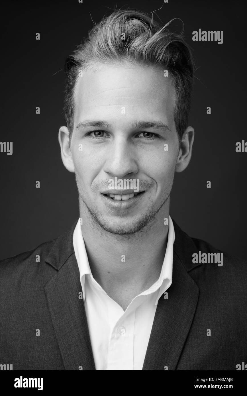 Young handsome businessman wearing costume en noir et blanc Banque D'Images