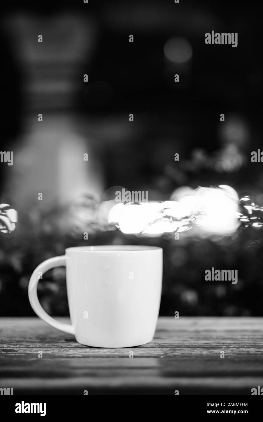 Tasse à café sur table en bois dans le restaurant de nuit Banque D'Images