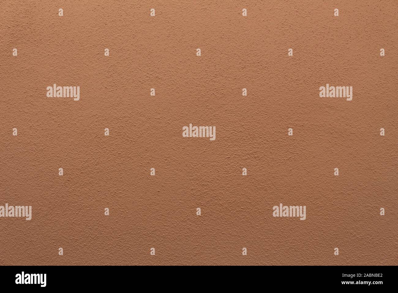 Mur de plâtre brun-orange, bien texturé pour le fond ou le papier peint Banque D'Images
