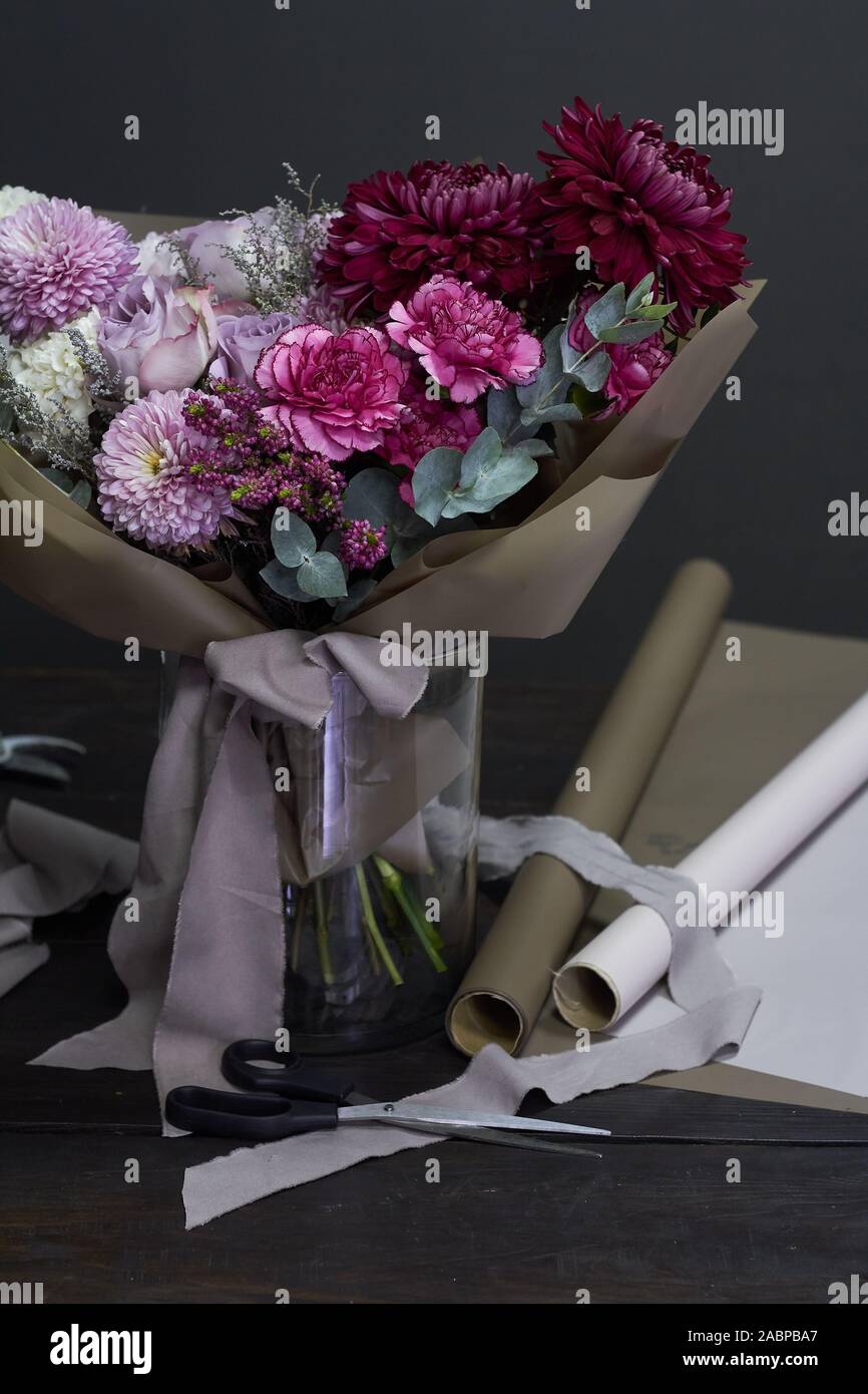 Les fleuristes et de bureau aux couleurs pourpre style vintage en bouquet sur un fond sombre, selective focus Banque D'Images