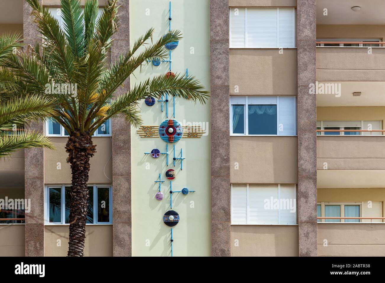 Photo en gros plan d'un mur décoré d'un immeuble résidentiel avec un ornement floral à côté d'un palmier, la Turquie. Banque D'Images