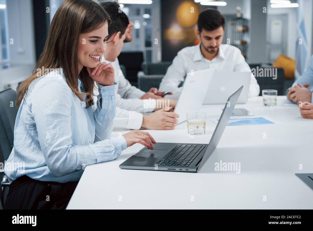 La Joie D Un Travail Vue De Cote De Fille Travaille Sur L Ordinateur Portable De Couleur Argent A L Office Photo Stock Alamy