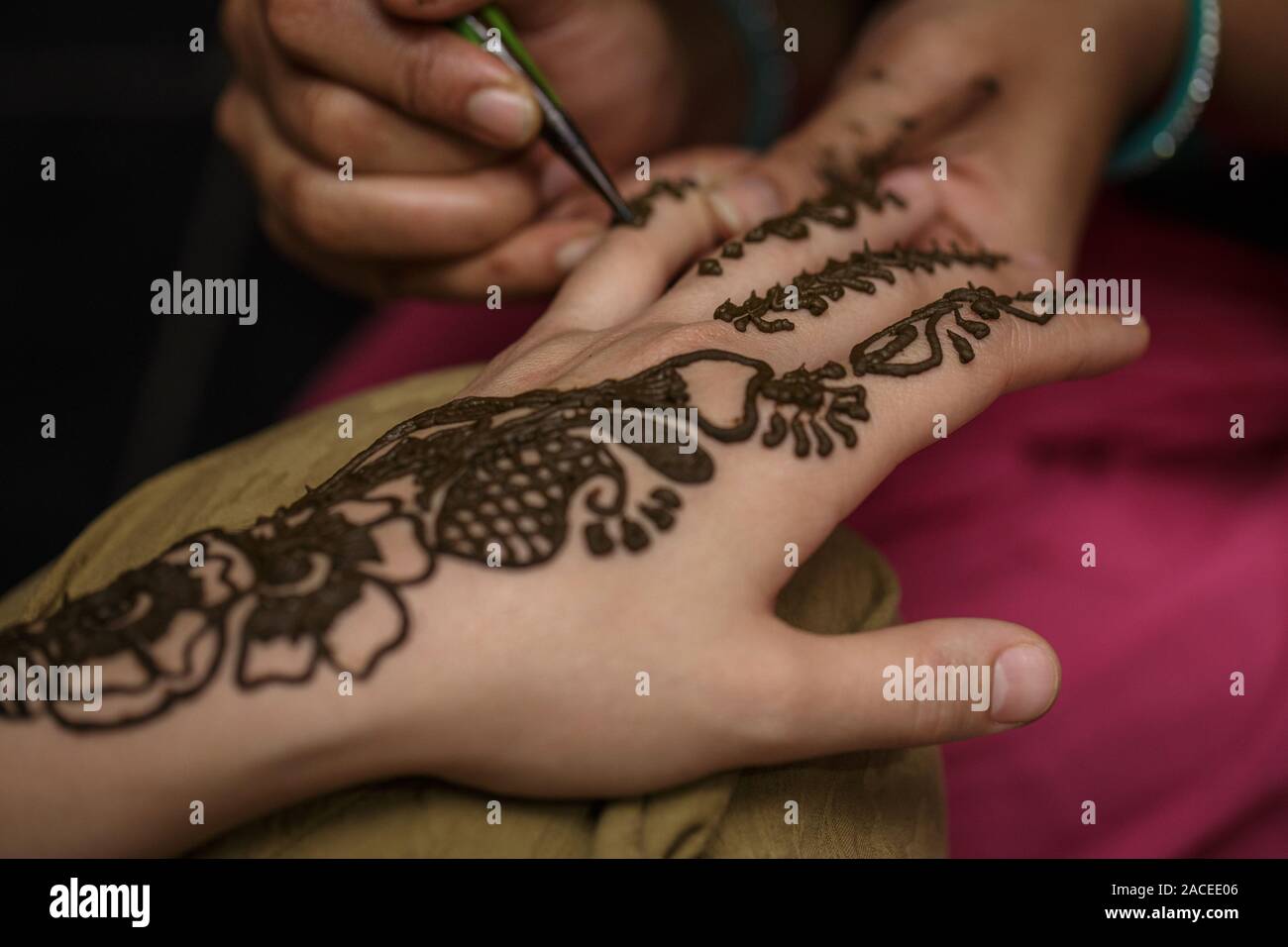 Le processus d'élaboration d'un dessin au henné mehendi sur la fille main. Tatouage au henné peinture Banque D'Images